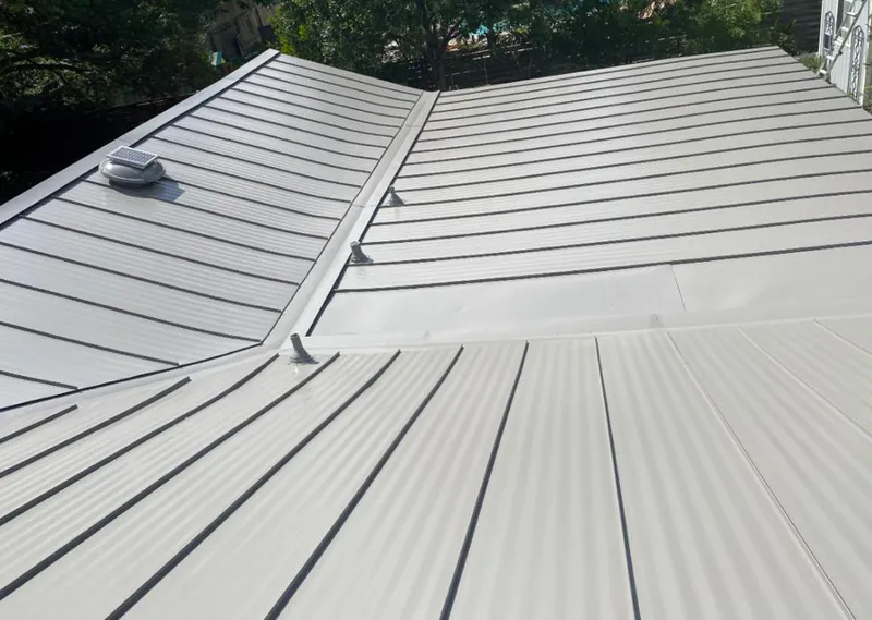 Solar attic fan installed on a metal roof for Roof Ventilation in Westchester
